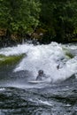 Teenager surfing the Pipeline wave on the Lochsa River, Idaho