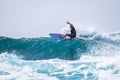 Teenager surfing at the wave in tenerife playa de las americas - red wetsuits and beautiful and perfect wave