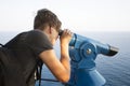 Teenager surveillances through telescope