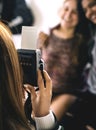 Teenager taking a picture of her friends