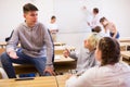 Teenager talking with classmates during recess in classroom Royalty Free Stock Photo