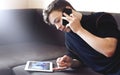 Teenager talking on the phone lying on the couch