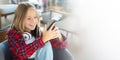 Teenager, technology and communication concept - smiling girl texting on smartphone with copy space Royalty Free Stock Photo
