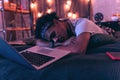 Teenager tired of having fun all day and falling asleep right next to laptop.