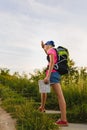 Teenager traveler with backpacks climbs the mountain. Wanderlust travel concept