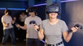 teenager in virtual reality glasses with joystick play survival game in tone jungle of future