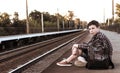 Teenager waiting for a train at the station