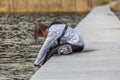 Teenager wakeboarding sits on the bridge after falling into the water after an unsuccessful jump