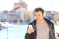 Teenager walking listening music from smart phone