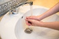 Washing hands in the bathroom sink. Frequent hand washing is a prerequisite for good hygiene in the face of the