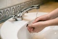 Washing hands in the bathroom sink. Frequent hand washing is a prerequisite for good hygiene in the face of the