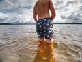 Teenager in water. Blond hair boy go swimming in the pond Royalty Free Stock Photo