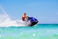Teenager on water scooter. Teen age boy water skiing. Royalty Free Stock Photo