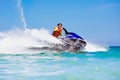 Teenager on water scooter. Teen age boy water skiing. Royalty Free Stock Photo