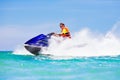 Teenager on water scooter. Teen age boy water skiing. Royalty Free Stock Photo