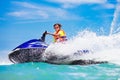 Teenager on water scooter. Teen age boy water skiing. Royalty Free Stock Photo