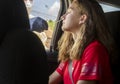 Teenage girl in vehicle getting nasal swab at COVID19 drive through coronavirus testing facility
