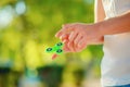 Teenager on the white t-shirt hand holding relaxing gadget fidg