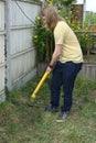 Teenager Working With Garden Trimmer