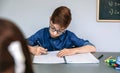 Teenager writing in notebook at school Royalty Free Stock Photo