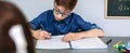Teenager writing in notebook at school Royalty Free Stock Photo