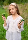 Teenager, 12 year old white girl with a fresh cucumbers smiles on a green Royalty Free Stock Photo