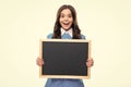 Teenager younf school girl holding school empty blackboard isolated on white background. Portrait of a teen female