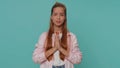 Teenager young girl child kid praying, looking upward and making wish, asking help, begging apology Royalty Free Stock Photo