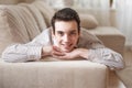 Teenager young man lying on sofa at home Royalty Free Stock Photo