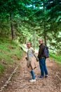 Teenagers with backpacks hiking in forest. Summer vacation. Royalty Free Stock Photo