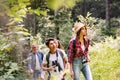 Teenagers with backpacks hiking in forest. Summer vacation. Royalty Free Stock Photo