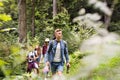 Teenagers with backpacks hiking in forest. Summer vacation. Royalty Free Stock Photo