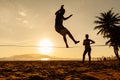 Teenagers balance on slackline silhouette Royalty Free Stock Photo