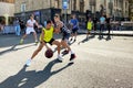 Teenagers boys play street basketball in the city. Small teams of three by three players