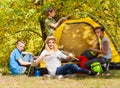 Teenagers build yellow tent during autumn day Royalty Free Stock Photo