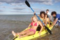 Teenagers in canoe in the sea Royalty Free Stock Photo