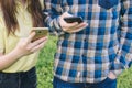 Teenagers chating online. Students holding mobile phones