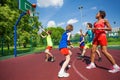 Teenagers in colorful uniforms playing basketball Royalty Free Stock Photo