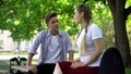 Teenagers couple conflicting, sitting at park bench, conflict based on jealousy Royalty Free Stock Photo