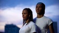 Teenagers couple in white T-shirts looking forward together, sharing same goals