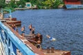 Teenagers dive into the water from the old rusty bridge over the Inhul river