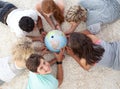 Teenagers examining a terrestrial globe Royalty Free Stock Photo