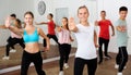 Teenagers exercising with coach in choreography class