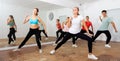 Teenagers exercising with coach in choreography class