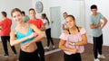 Teenagers exercising with coach in choreography class