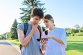 Teenagers friends talking looking at smartphone screen