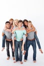 Teenagers giving their friends piggyback rides Royalty Free Stock Photo