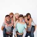 Teenagers giving their friends piggyback rides Royalty Free Stock Photo