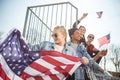 Teenagers group having fun and waving american flags at sunset Royalty Free Stock Photo