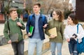Teenagers have fun talking on street